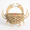 Front view of a crab-shaped water hyacinth storage basket on a pure white background.