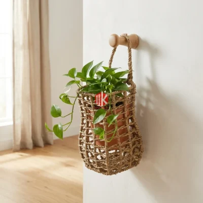 A handwoven seagrass open weave basket used as a hanging planter in a sunlit modern living room.