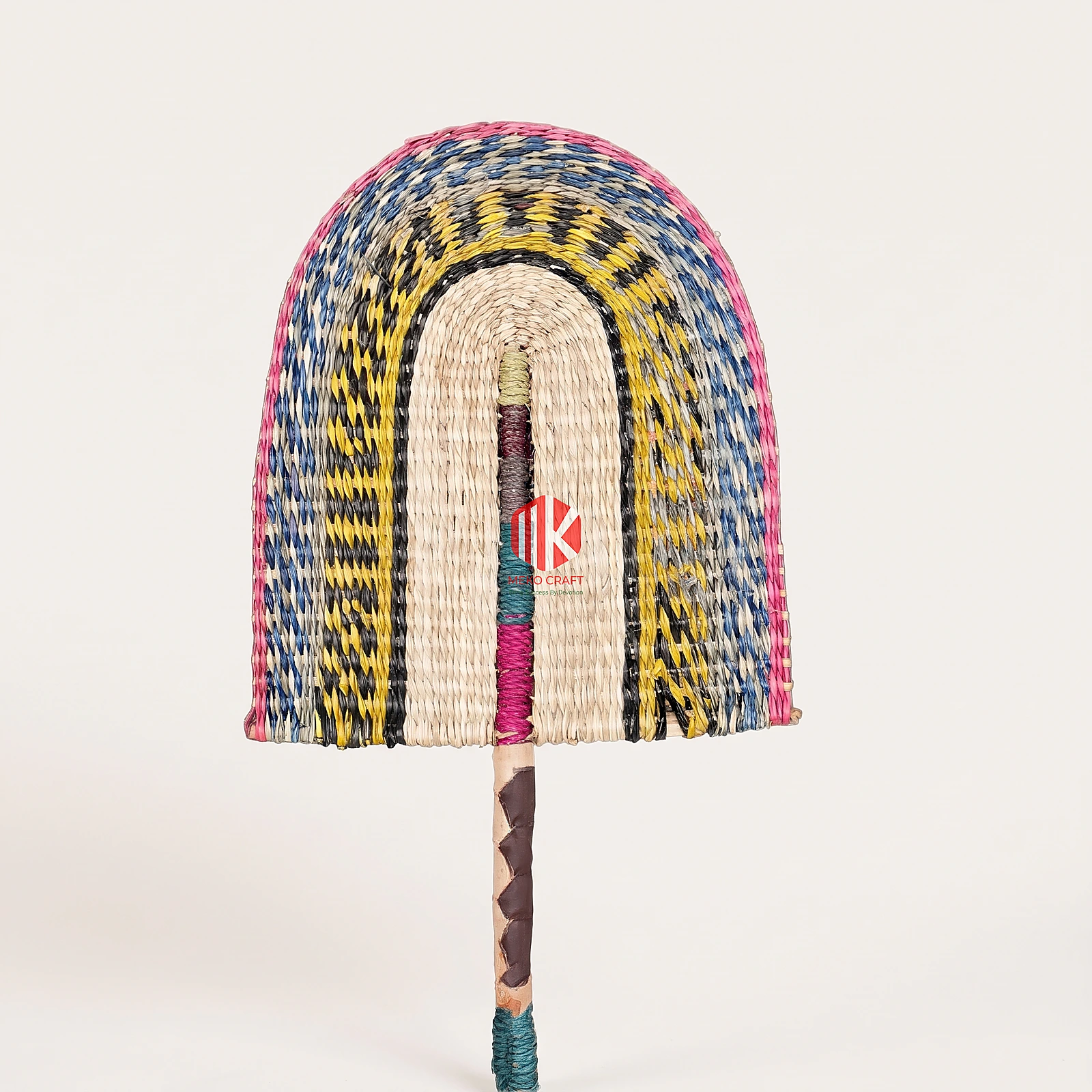 Multicolor Twill Woven Palm Leaf Hand Fan 3 A studio shot of a multicolor arched palm leaf hand fan with a brown wrapped handle against a white background.