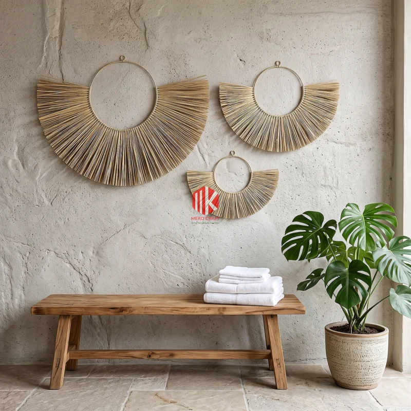 Handwoven Palm Leaf Fan Wall Decor Set of 3 8 A set of three palm leaf fan wall decors hung in a staggered arrangement on a white plaster wall in a luxury spa lounge.