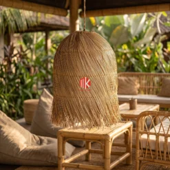 Spiral Woven Palm Leaf Lampshade with Shaggy Fringe 8 Bell shaped layered palm leaf pendant lampshade in a tropical eco-resort lounge hanging above a bamboo side table