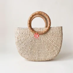 Meko Craft - Vietnam Handicraft Factory 10 Studio shot of a semi-circular seagrass bag with round rattan handles on a white background showing the sunburst weave pattern.