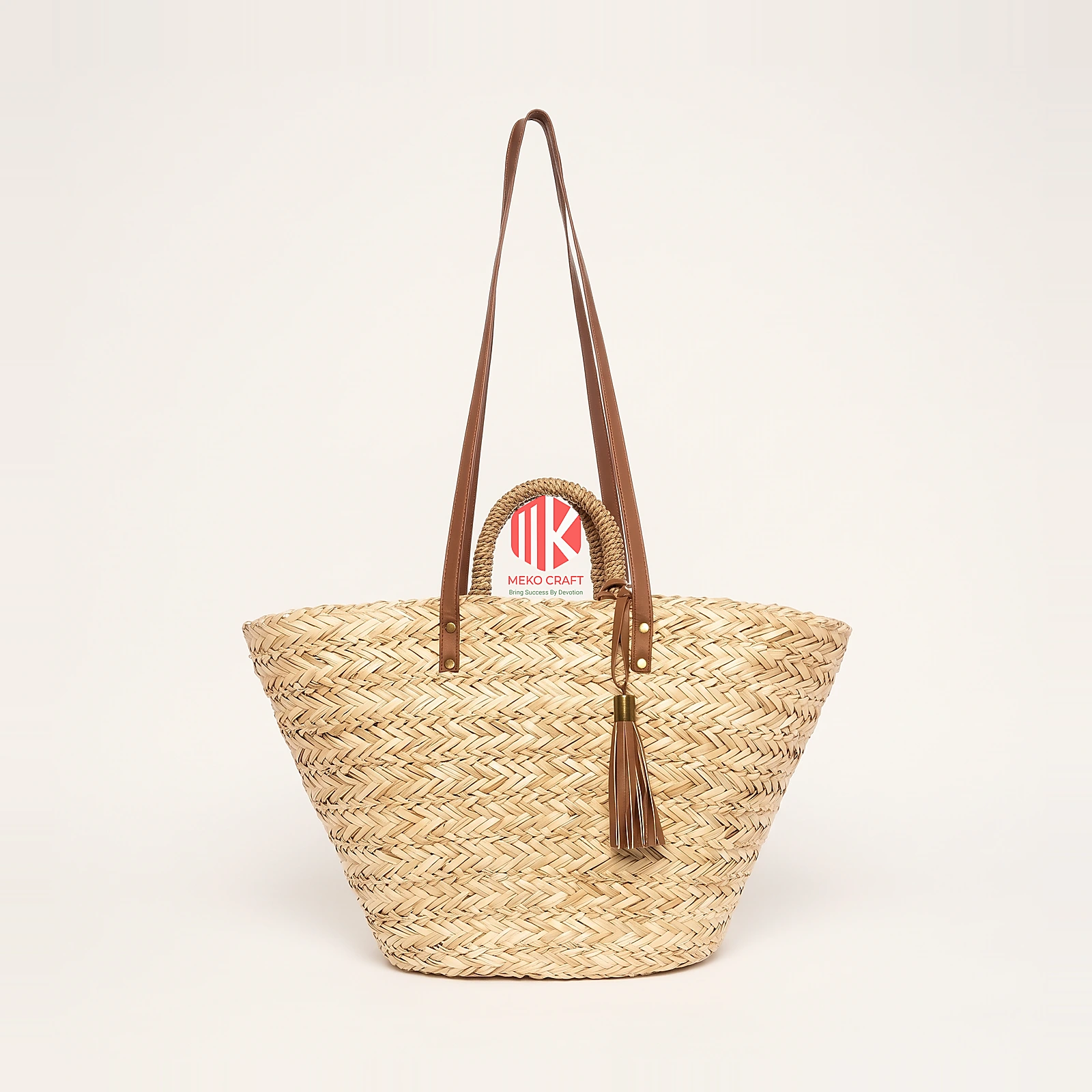 Handwoven Twill Palm Leaf Handbag with Tassel 4 Studio shot of a handwoven palm leaf handbag with brown straps and a tassel, showing the tight twill weave against a white background.