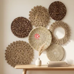 A set of patterned mixed material wall decor plates displayed artfully on a light-colored living room wall, creating visual interest above a console table.