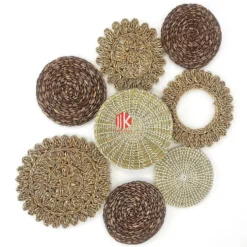 Eight round patterned wall decor plates crafted from coiled and woven mixed natural fibers, showcasing varied textures and natural tones on a white background.