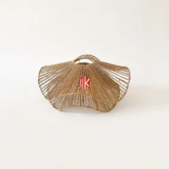 Handwoven seagrass lampshade with a scalloped edge and twisted fiber texture shown against a white background.